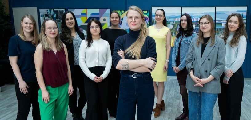 A group of researchers at the genomics institute of the University of Tartu pose in front of the camera to capture an epic group photo.